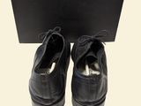 men ' s black leather shoes with laces and a black box