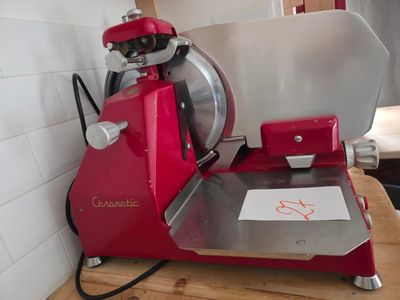 a red machine that is sitting on top of a wooden table