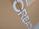 a cardboard box that has a sign on the side of it