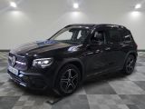 the mercedes gls is parked on a checkered floor