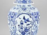blue and white ginger jar with a bird on top of it