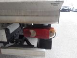 a red object on the back of a silver truck
