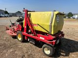 an image of a tractor with a yellow container on the back