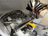 a sink with a bunch of kitchen utensils in it