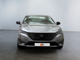 the front of a silver car in a white room