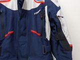 the jacket is blue and white with red accents on it