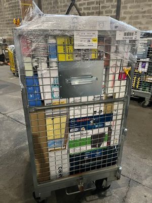 a metal cart with many boxes on it in a warehouse