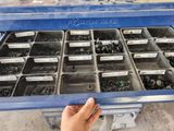 a person that is holding a tray of screws