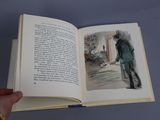 a person holding an open book with a picture of a man in a suit