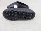 a pair of black shoes that are on a white surface
