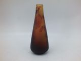 a vase with a brown and red design on it