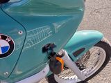 a blue motorcycle parked on the side of the road