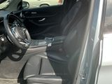 the interior of a car with the door open and the driver ' s seat down