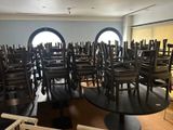 many chairs and tables in a room with a lot of windows