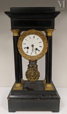 a black and gold clock sitting on top of a table