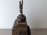 a clock that is sitting on a table with a bird on it