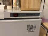 a white machine that is sitting on top of a counter