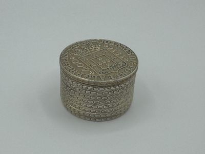 an image of a silver box sitting on top of a white surface