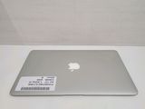 a silver apple laptop sitting on a white table