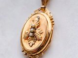 an image of a gold locke with a bee on it