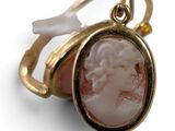 an image of a gold ring with a cameo of a woman ' s face