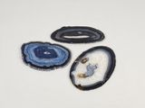 three pieces of blue and white agate on a white surface