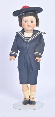 a doll of a boy in a sailor suit and hat
