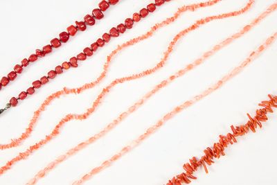 de nombreuses perles de différentes couleurs sur un fond blanc