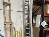 a room with a ladder, a ladder, and other items in it