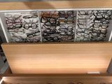 many pairs of glasses on display in a display case