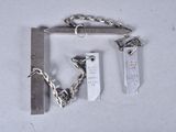 a silver chain with a tag attached to it next to a hammer
