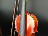 a violin and a violin case sitting next to each other