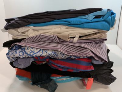 a pile of clothes sitting on top of a white table