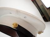 a white hat with gold buttons on it sitting on a table