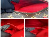 the inside of a louis vuitton bag with the zipper open