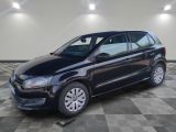 La Volkswagen Polo noire est garée dans une pièce dont le sol est en damier.