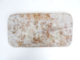 rectangular marble tray with orange and white speckles on white surface
