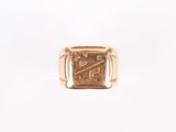 a close up of a gold ring with a design on it