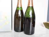 two bottles of wine sitting on a table next to a box