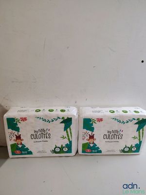 two boxes of toilet paper sitting on top of a white counter