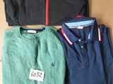 three men ' s sweaters are sitting on top of a cardboard box