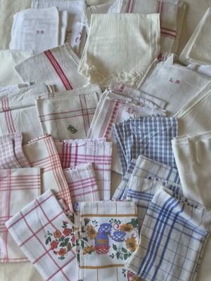 many different types of handkerchiefs laid out on a bed