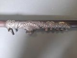 a silver object on the handle of a silver spoon