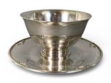 an image of a silver plate with a bowl and saucer on it
