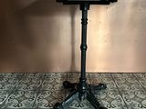 a table with a black top sitting on a tiled floor