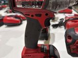 a red cordless drill that is sitting on a table