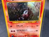 un gros plan sur une carte Pokémon dans une boîte en plastique