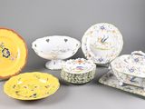 many different types of plates and bowls on the table