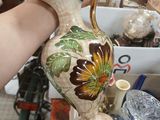 a person that is holding a vase in their hand