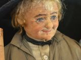 a doll of a man with a hat and a cane